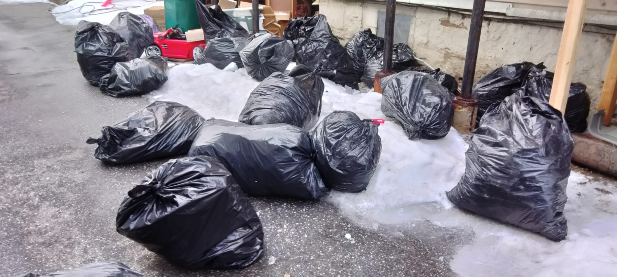 Bags of trash in snowy street